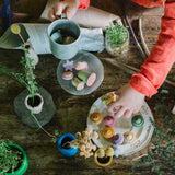 Kind spielt mit Grapat Flower Meadow Holzfiguren in Form von Blüten und Blumen