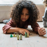 Kind auf Boden spielt mit Forest Tree Holzbäumen von Grapat