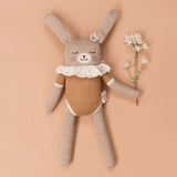 Großer Hase von Main Sauvage aus Alpakawolle mit senffarbenem Body mit Blume in der Hand