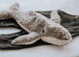 Kleiner Wal Kuscheltier und Wärmekissen von Senger Naturwelt auf Babykleidung liegend